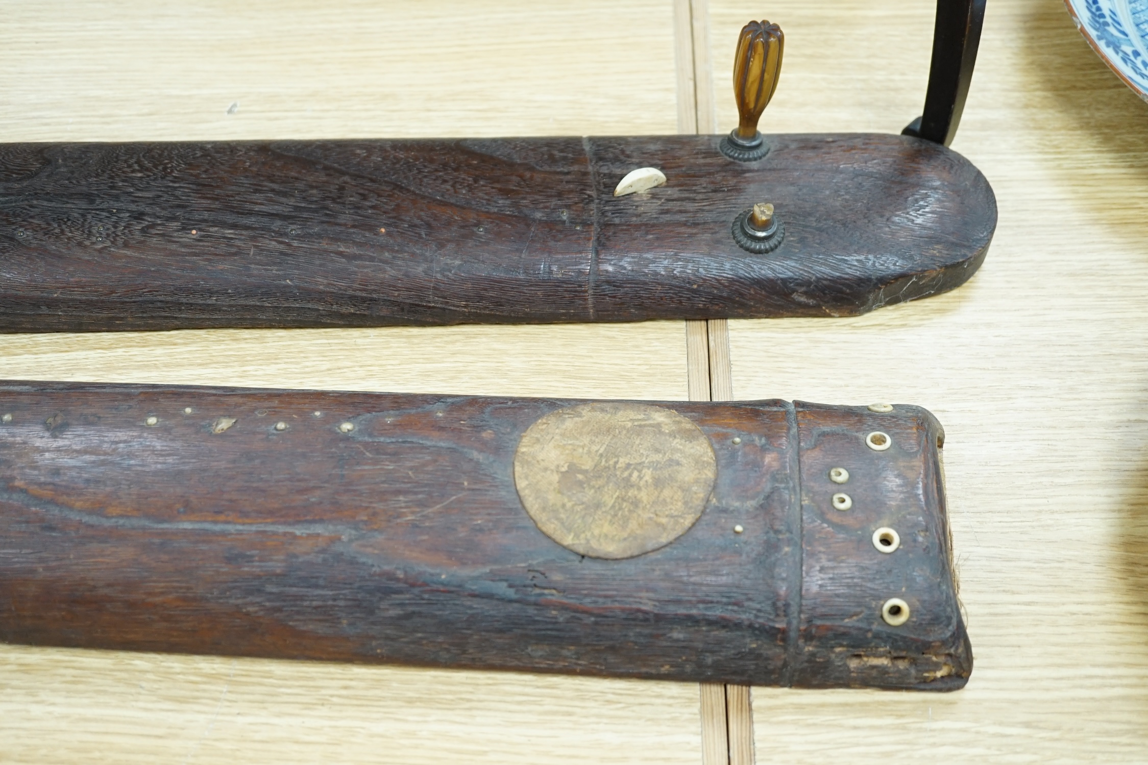 Two Japanese musical instruments and a stand, together with three catalogues, instruments 108cm long